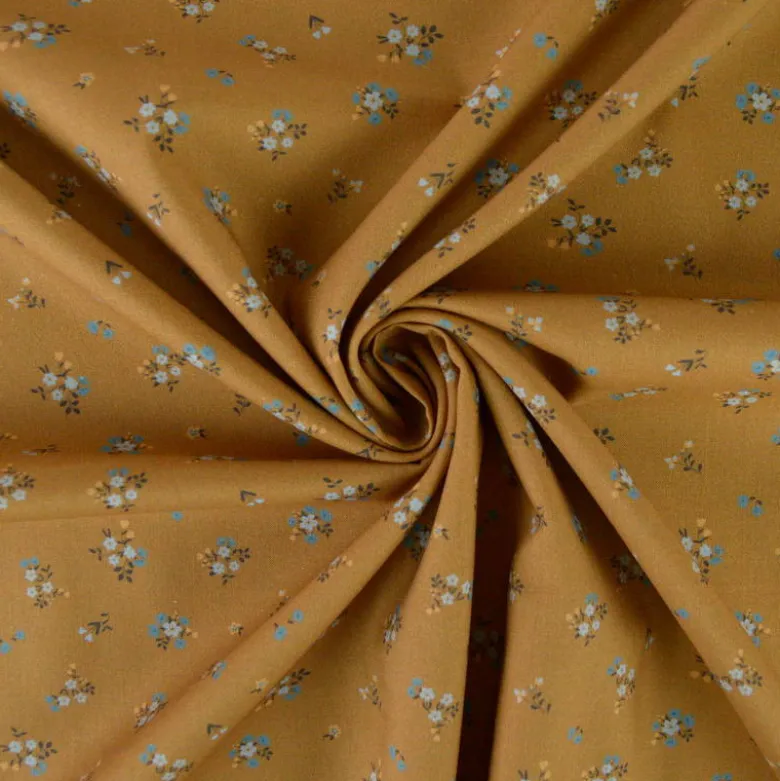 Popeline de coton Bisou motif fleurs bleues fond Ocre