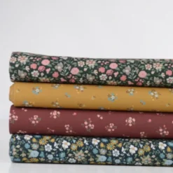 Popeline de coton Bisou motif fleurs bleues fond Ocre