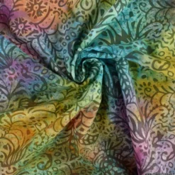Tissu Batik fond motifs fleuris violet, jaune et bleu