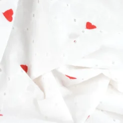 Tissu broderie anglaise brodé coeurs rouges fond blanc
