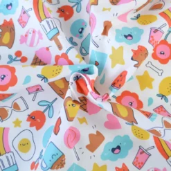 Tissu coton enduit Kawi motifs kawaii multicolores