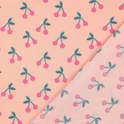 Tissu coton Enduit motifs cerises fond rose