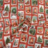 Tissu cretonne coton Noël motif timbres vintage fond rouge