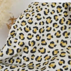Tissu demi natté coton motif léopard doré fond aspect lin