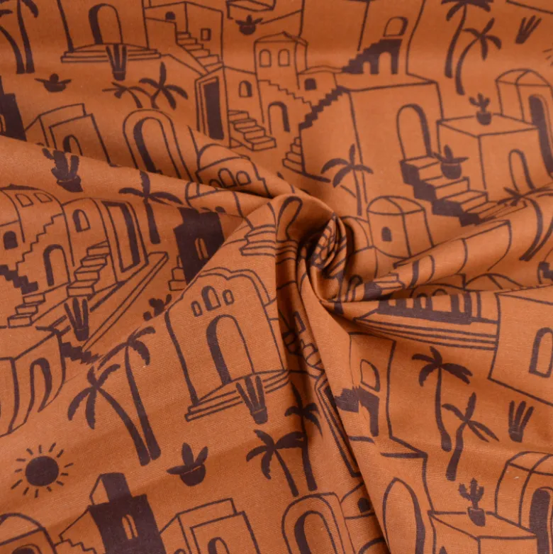 Tissu demi-natté imprimé médina maisons et palmiers fond caramel