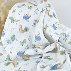 Tissu double gaze de coton Ceradino motif dinosaures fond à carreaux blanc