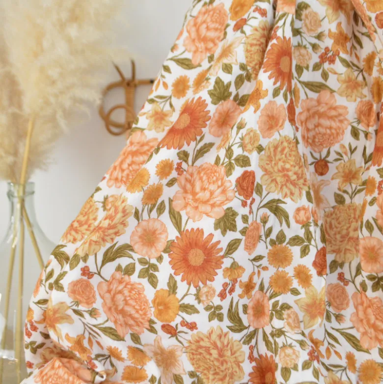 Tissu double gaze de coton Elisabeth motif fleurs tons orangés et rose