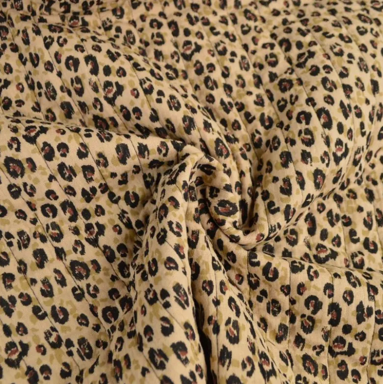 Tissu double gaze de coton matelassé léopard beige envers noir
