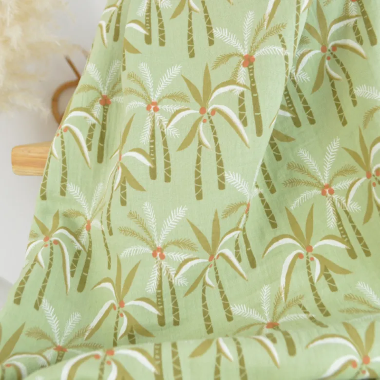 Tissu double gaze de coton Paloum motif palmiers fond amande