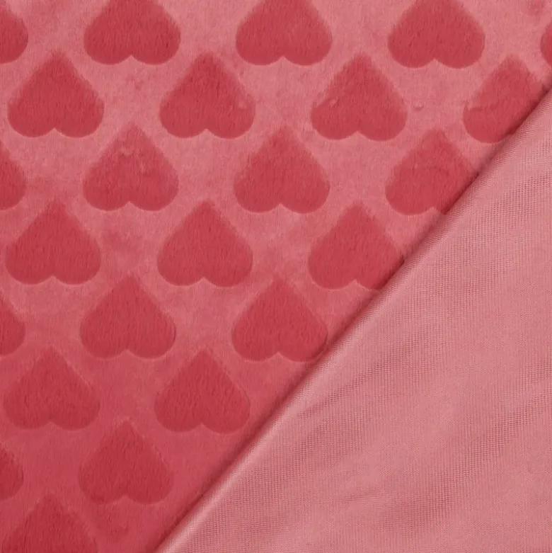 Tissu fausse fourrure structurée motif coeurs - Rose corail