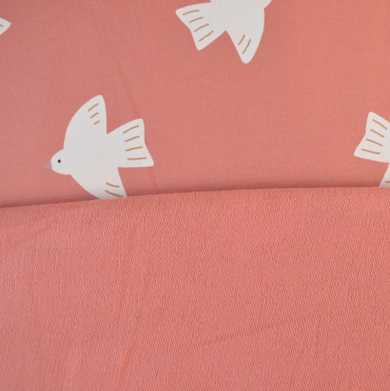 Tissu French Terry coton – Motif oiseaux fond rose corail - OEKO TEX