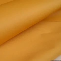 Tissu Gabardine enduite étanche ocre moutarde.