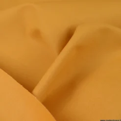 Tissu Gabardine enduite étanche ocre moutarde.