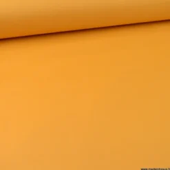 Tissu Gabardine enduite étanche ocre moutarde.