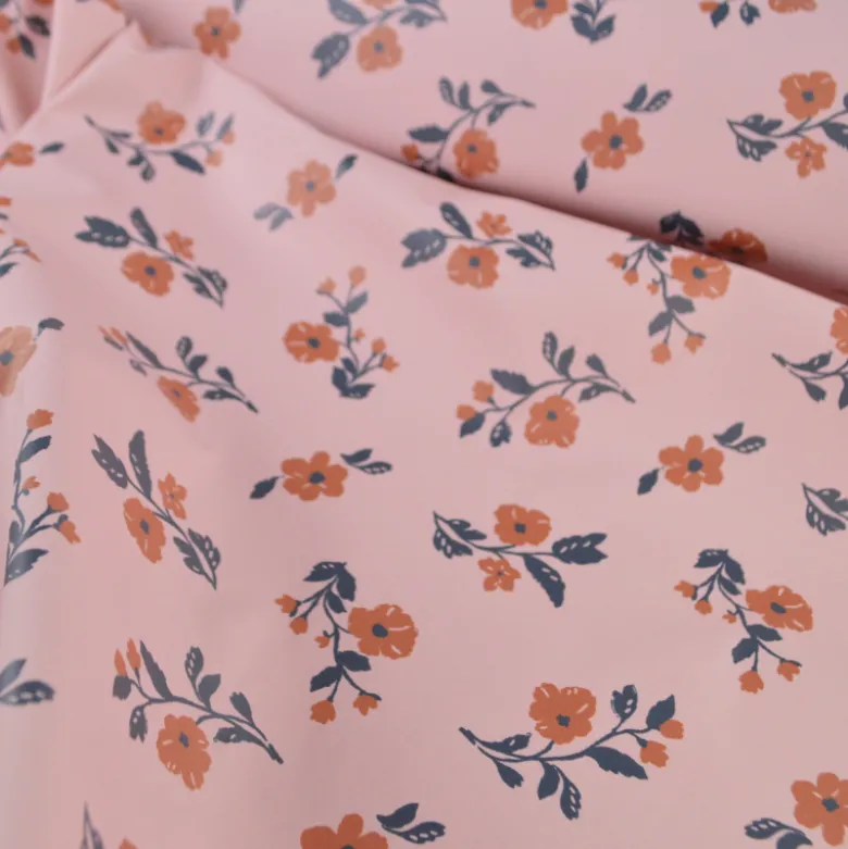 Tissu imperméable Alina type ciré de pluie motif fleurs fond Nude