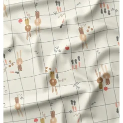 Tissu imperméable Ilapio type ciré motif lapins fond écru