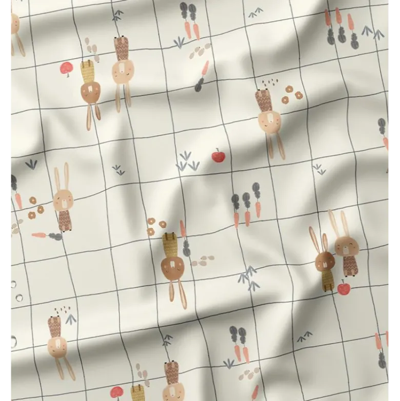 Tissu imperméable Ilapio type ciré motif lapins fond écru