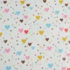 Tissu imperméable Tiamo type ciré de pluie motif coeurs bleus et roses
