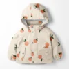 Tissu imperméable type ciré motif fruits fond rose clair