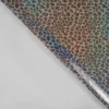 Tissu imperméable type ciré motif léopard à paillettes