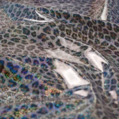 Tissu imperméable type ciré motif léopard à paillettes
