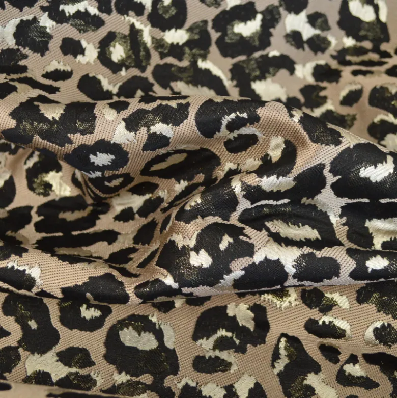 Tissu jacquard Habillement Leopard noir et doré fond beige