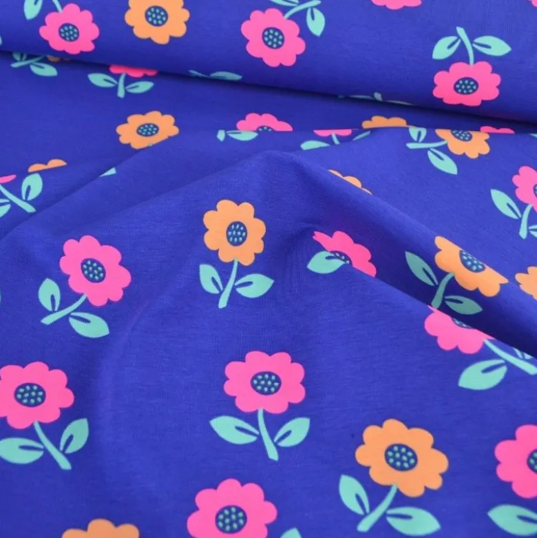Tissu jersey coton Poppy motif fleurs rose fluo - fond Cobalt