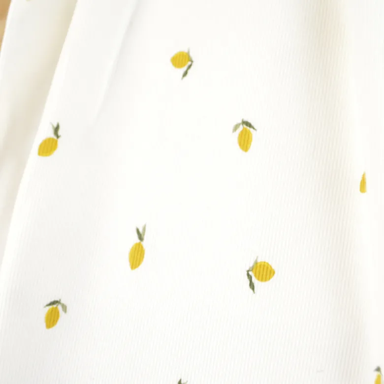 Tissu jersey côtelé fines côtes – Motif citrons fond blanc cassé