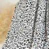 Tissu jersey côtelé fines côtes – Motif léopard noir fond blanc cassé