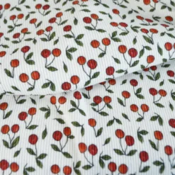 Tissu jersey côtelé motif cerises fond blanc cassé