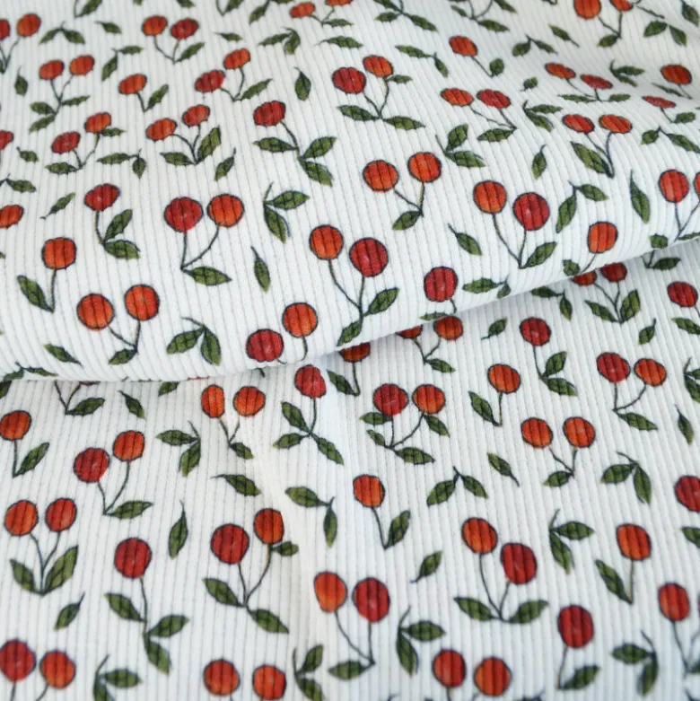 Tissu jersey côtelé motif cerises fond blanc cassé
