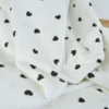 Tissu jersey côtelé motif coeurs Noirs fond blanc