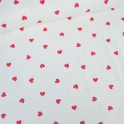 Tissu jersey côtelé motif coeurs rouges fond blanc