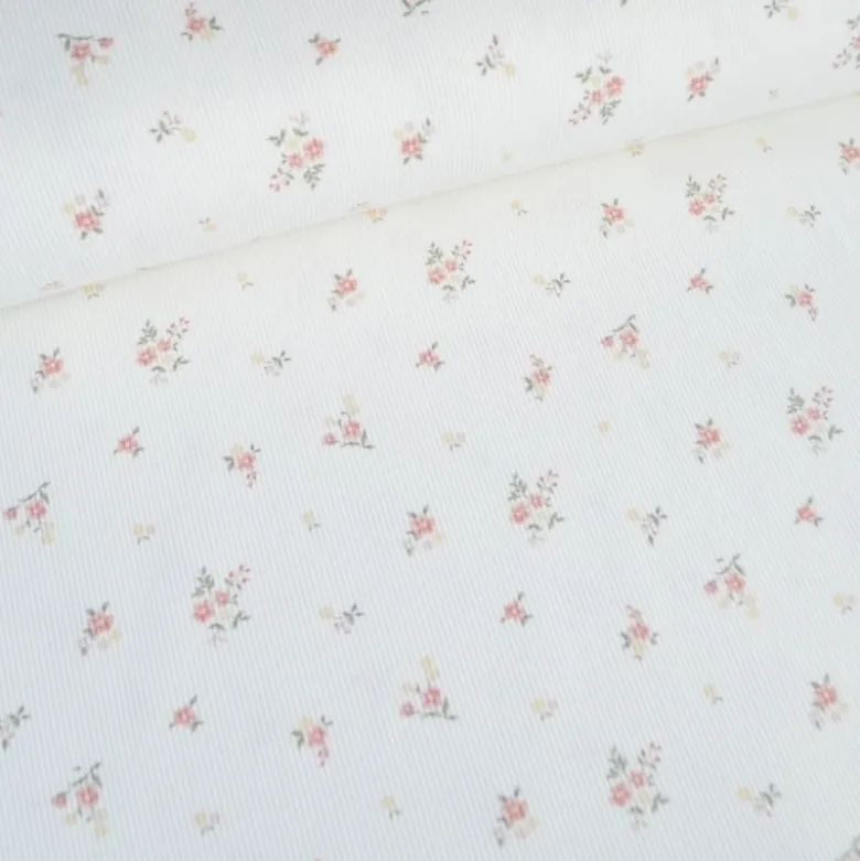 Tissu jersey côtelé motif fleurs roses fond blanc cassé