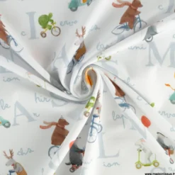 Tissu jersey motif animaux faisant du vélo fond blanc