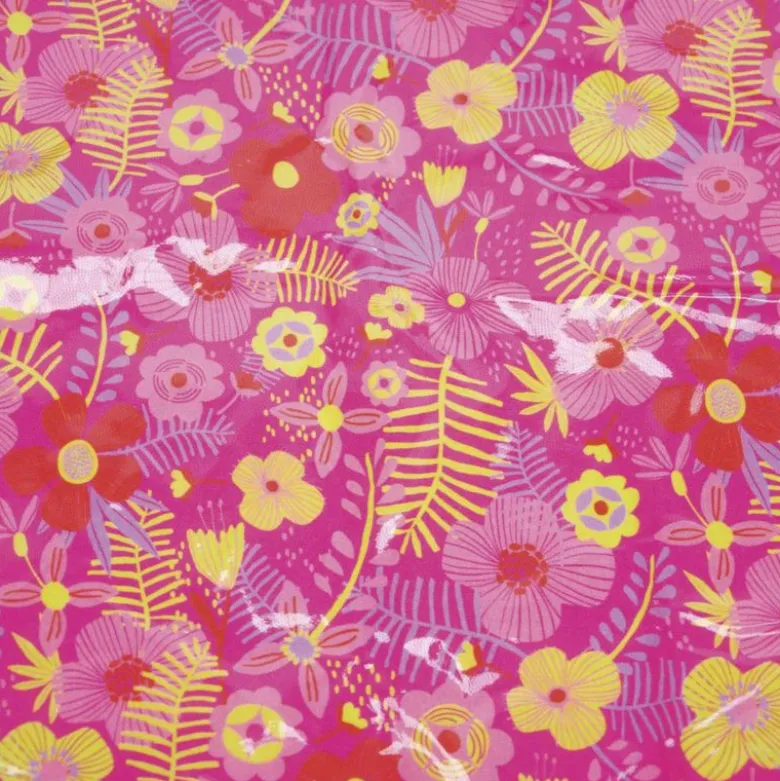 Tissu plastifié imprimé fleurs sur fond fuchsia