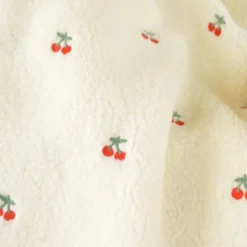 Tissu Sherpa brodée motif cerises fond écru