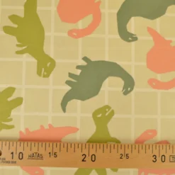 Tissu Sweat French terry motif dinosaures fond amande - OEKO TEX