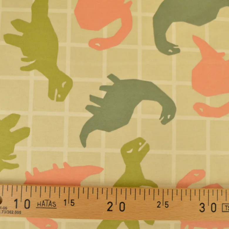 Tissu Sweat French terry motif dinosaures fond amande - OEKO TEX