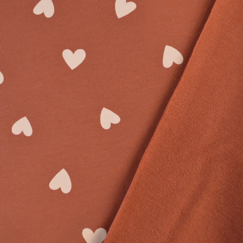 Tissu Sweat French terry motif coeurs fond vieux rose - OEKO TEX