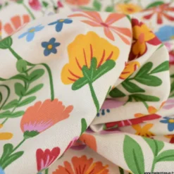 Tissu toile imprimée fleurs multicolores sur fond écru