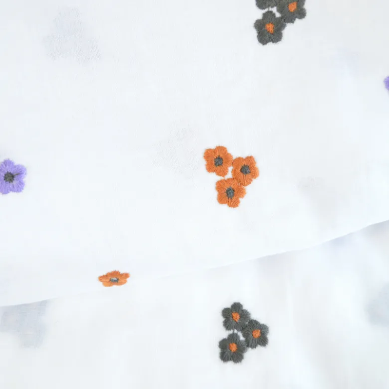 Voile de coton brodé de petites fleurs camel fond blanc