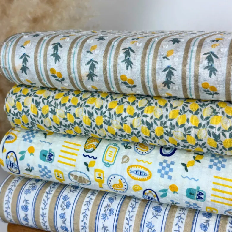 Voile plumetis rayures et citrons fond écru